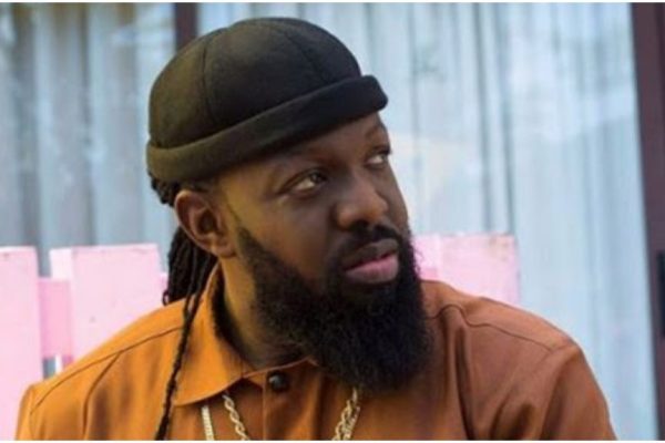 Timaya falls on stage while trying to lift plus-sized woman during performance